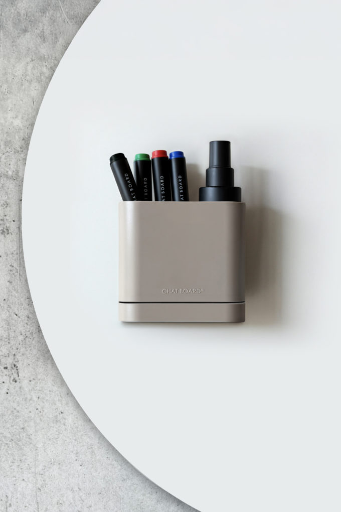 CHAT BOARD Dock storage unit with integrated eraser sponge - in greige, shown on Orbit glass board, and with pens and cleaner spray